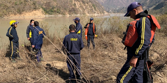 Rescuers prepare to search for bodies in the downstream of Alaknanda River in Rudraprayag, northern state of Uttarakhand, India, Monday, Feb.8, 2021. More than 2,000 members of the military, paramilitary groups and police have been taking part in search-and-rescue operations after part of a Himalayan glacier broke off Sunday and sent a wall of water and debris rushing down the mountain. (AP Photo/Rishabh R. Jain)