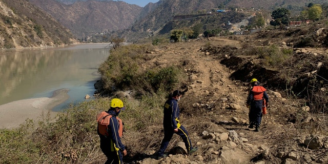 Rescuers arrive to search for bodies in the downstream of Alaknanda River in Rudraprayag, northern state of Uttarakhand, India, Monday, Feb.8, 2021. More than 2,000 members of the military, paramilitary groups and police have been taking part in search-and-rescue operations after part of a Himalayan glacier broke off Sunday and sent a wall of water and debris rushing down the mountain. (AP Photo/Rishabh R. Jain)