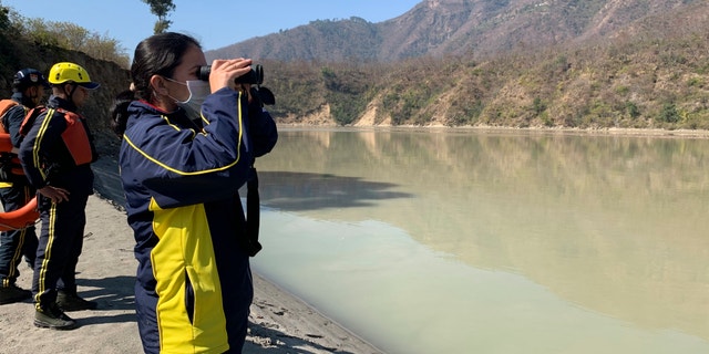 Rescuers search for bodies in the downstream of Alaknanda River in Rudraprayag, northern state of Uttarakhand, India, Monday, Feb.8, 2021. More than 2,000 members of the military, paramilitary groups and police have been taking part in search-and-rescue operations after part of a Himalayan glacier broke off Sunday and sent a wall of water and debris rushing down the mountain. (AP Photo/Rishabh R. Jain)