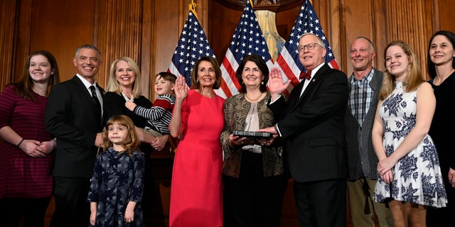 In this Jan. 3, 2019 file photo, House Speaker Nancy Pelosi of Calif., poses during a ceremonial swearing-in with Rep. Ron Wright, R-Texas, fourth from right, on Capitol Hill in Washington during the opening session of the 116th Congress. (AP Photo/Susan Walsh, File)