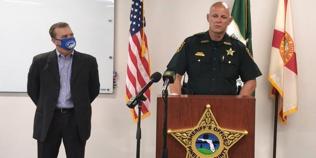 In this screenshot from a YouTube video posted by the Pinellas County Sheriff's Office, Pinellas County Sheriff Bob Gualtieri speaks at a press conference as Oldsmar, Fla. Mayor Eric Seidel, left, listens, Monday February 8, 2021, in Oldsmar, Fla. (Pinellas County Sheriff's Office via AP)