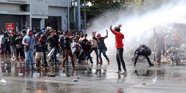 Police use water cannon to disperse demonstrators during a protest in Mandalay, Burma, Tuesday, Feb. 9, 2021. Police were cracking down on the demonstrators against Burma’s military takeover who took to the streets in defiance of new protest bans. (AP Photo)