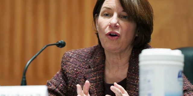 Sen. Amy Klobuchar, D-Minn., gives open remarks before the Senate Homeland Security and Government Affairs committee on nomination of Neera Tanden to become the Director of the Office of Management and Budget (OMB), during a hearing, Tuesday, Feb. 9, 2021 on Capitol Hill in Washington. (Leigh Vogel/Pool via AP)