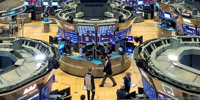 In this photo provided by the New York Stock Exchange, traders work on the floor, Tuesday, Feb. 9, 2021.  (Courtney Crow/New York Stock Exchange via AP)