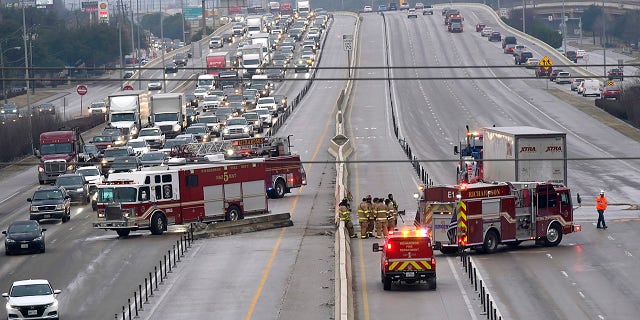 The highway sits closed as emergency crews finish cleaning following accidents caused by ice and low temperatures in Richardson, Texas, Thursday, Feb. 11, 2021. A winter storm brought a coating of ice to parts of Texas. (AP Photo/LM Otero)