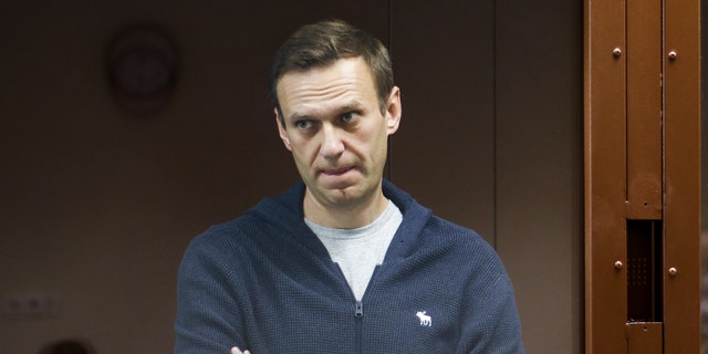 In this photo taken on Friday, Feb. 12, 2021 and provided by the Babuskinsky District Court, Russian opposition leader Alexei Navalny stands in a cage during a hearing on charges of defamation in the Babuskinsky District Court in Moscow, Russia. (Babuskinsky District Court Press Service via AP)