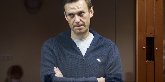 In this photo taken on Friday, Feb. 12, 2021 and provided by the Babuskinsky District Court, Russian opposition leader Alexei Navalny stands in a cage during a hearing on charges of defamation in the Babuskinsky District Court in Moscow, Russia. (Babuskinsky District Court Press Service via AP)