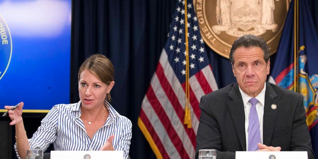 FILE: Secretary to the Governor Melissa DeRosa, is joined by New York Gov. Andrew Cuomo as she speaks to reporters during a news conference, in New York.
