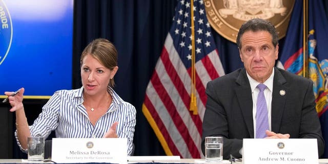 Secretary to the Governor Melissa DeRosa is joined by New York Gov. Andrew Cuomo as she speaks to reporters during a news conference, a New York City, Sett. 14, 2018. (Associated Press)