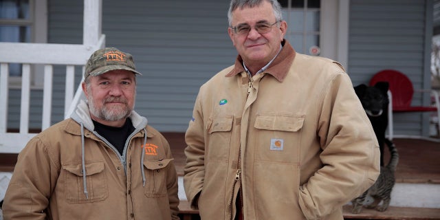 Victor Nemec, left, and Nick Nemec pose outside Nick Nemec's home in Holabird, S.D., Friday, Jan. 29, 2021. (AP Photo/Stephen Groves)