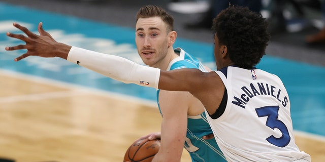 Charlotte Hornets forward Gordon Hayward, left, looks for a pass against Minnesota Timberwolves forward Jaden McDaniels during the second half of an NBA basketball game in Charlotte, NC, Friday, February 12. of 2021.