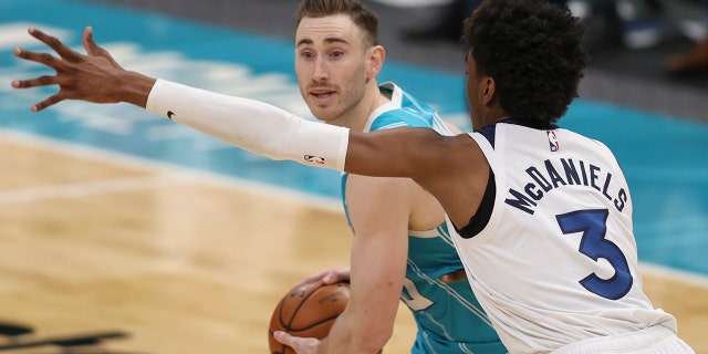 Charlotte Hornets forward Gordon Hayward, left, looks for a pass against Minnesota Timberwolves forward Jaden McDaniels during the second half of an NBA basketball game in Charlotte, NC, Friday, February 12. of 2021.