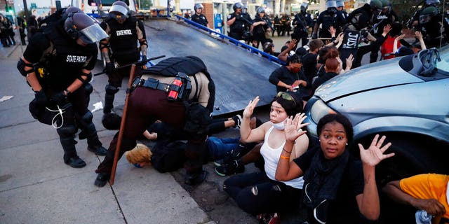 FILE: Demonstrators are taken into custody after curfew in Minneapolis, as protests continued following the death of George Floyd, who died after being restrained by Minneapolis police officers on Memorial Day.