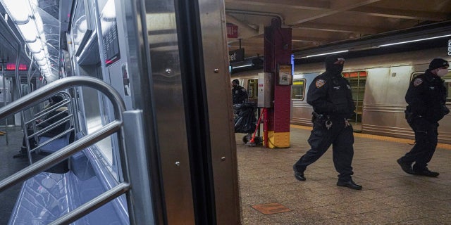 Police patrol the A line subway train bound to Inwood, after NYPD deployed an additional 500 officers into the subway system following deadly attacks, Saturday Feb. 13, 2021, in New York. (AP Photo/Bebeto Matthews)