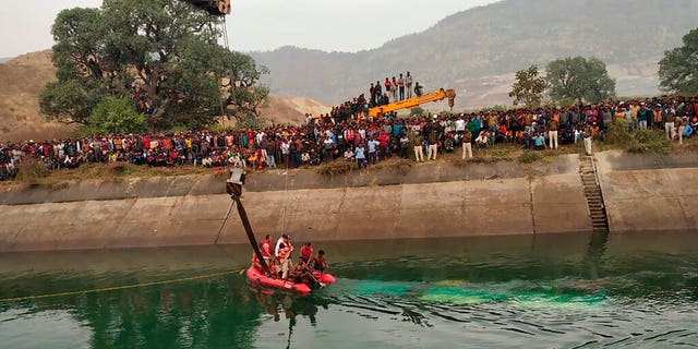 Rescuers work at the site of a bus accident in Sidhi district, in the central Indian state of Madhya Pradesh, Tuesday, Feb. 16, 2021. (Madhya Pradesh District Public Relation Office Sidhi via AP)