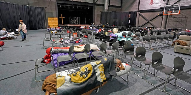 People seeking shelter from below freezing temperatures rest inside a church warming center Tuesday, Feb. 16, 2021, in Houston. (AP/David J. Phillip)