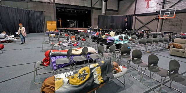 People seeking shelter from below freezing temperatures rest inside a church warming center Tuesday, Feb. 16, 2021, in Houston. (AP/David J. Phillip)