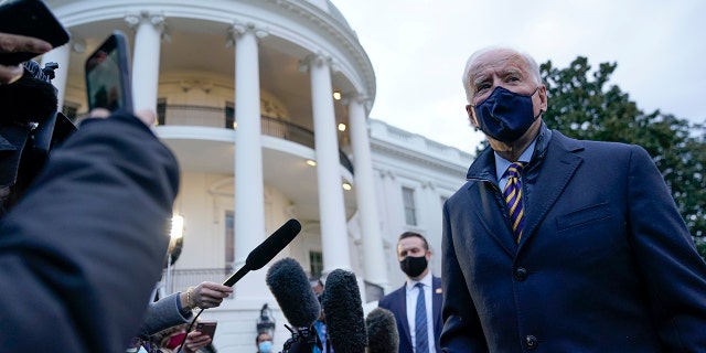 President Joe Biden talks to reporters on the South Lawn of the White House before boarding Marine One, Tuesday, Feb. 16, 2021, in Washington. (AP Photo/Patrick Semansky)