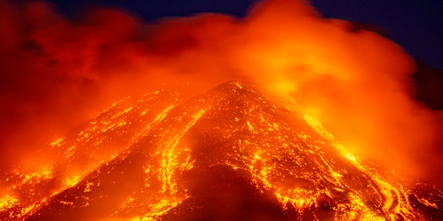 Lava gushes from the Mt Etna volcano near Catania, Sicily, Tuesday, Feb. 16, 2021. Europe's most active volcano came alive around 4 pm local time on Tuesday, according to the Italian Institute of Geophysics and Volcanology. (AP Photo/Salvatore Allegra)