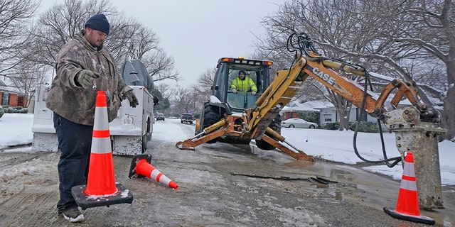 Workers in Richardson, Texas, prepare to work on a water main pipe that burst due to extreme cold in a neighborhood Wednesday, Feb. 17, 2021. (Associated Press)