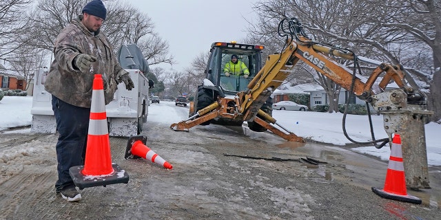Workers in Richardson, Texas, prepare to work on a water main pipe that burst due to extreme cold in a neighborhood Wednesday, Feb. 17, 2021. (Associated Press)