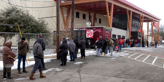 People stand in line outside an HEB grocery store in the snow Thursday, Feb. 18, 2021, in Austin, Texas. (Associated Press)