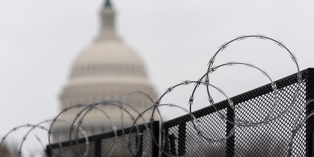 The U.S. Capitol is seen behind the razor-sharp fence around the U.S. Capitol on Thursday, February 18, 2021 (Associated Press)