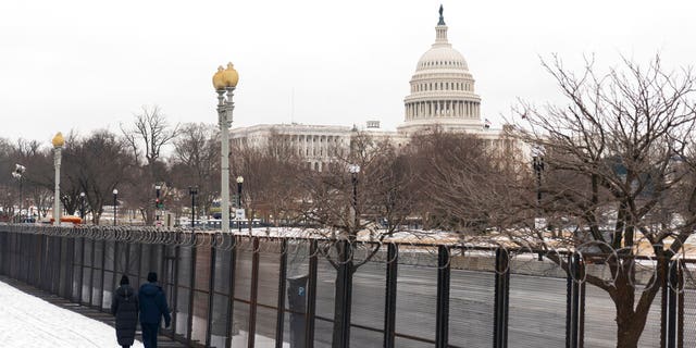 The U.S. Capitol is seen behind the metal security fencing around the U.S. Capitol, Thursday, Feb. 18, 2021. (AP Photo/Manuel Balce Ceneta)