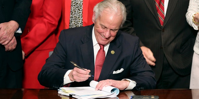 FILE PHOTO: South Carolina Gov. Henry McMaster signs into law a bill banning almost all abortions in the state Thursday, Feb. 18, 2021, in Columbia, S.C.