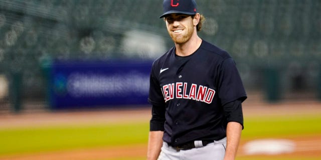 Shane Bieber has reported to training camp with the Cleveland Indians after recovering from COVID-19. The right-hander took part in drills on Saturday, Feb. 20, 2021, a day before the Indians hold their first full-squad workout in Goodyear, Ariz. (AP Photo/Paul Sancya, File)
