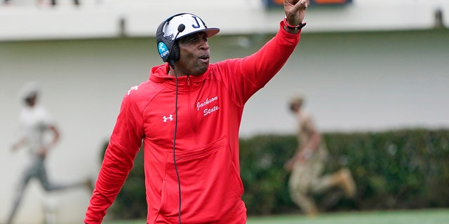 Jackson State football coach Deion Sanders calls out to his players during the first half of an NCAA college football against Edward Waters in Jackson, Miss., Sunday, Feb. 21, 2021. The game marks Sanders's collegiate head coaching debut. (AP Photo/Rogelio V. Solis)