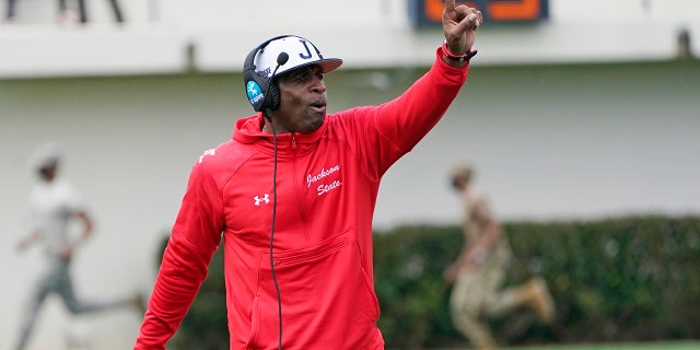 Jackson State football coach Deion Sanders calls out to his players during the first half of a game against Edward Waters in Jackson, Miss., Feb. 21, 2021. The game marked Sanders's collegiate head coaching debut. (AP Photo/Rogelio V. Solis)