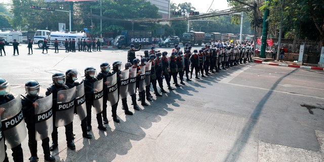 Police security forces form a line to block a road near the U.S. embassy in Yangon, Burma Monday, Feb. 22, 2021. Protesters gathered in Burma's biggest city Monday despite the ruling junta's thinly veiled threat to use lethal force if people answered a call for a general strike opposing the military takeover three weeks ago. (AP Photo)