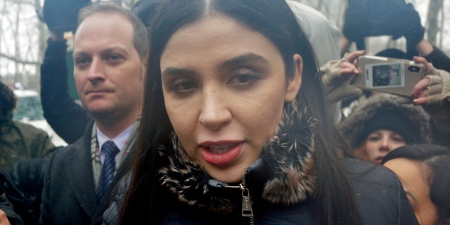 FILE - In this Feb. 12, 2019 file photo, Emma Coronel Aispuro, center, wife of Joaquin "El Chapo" Guzman, leaves federal court in New York. The wife of Mexican drug kingpin and escape artist Joaquin "El Chapo" Guzman has been arrested on international drug trafficking charges at an airport in Virginia. The Justice Department says 31-year-old Emma Coronel Aispuro, who is a dual citizen of the U.S. and Mexico, was arrested at Dulles International Airport on Monday and is expected to appear in federal court in Washington on Tuesday. (AP Photo/Seth Wenig)