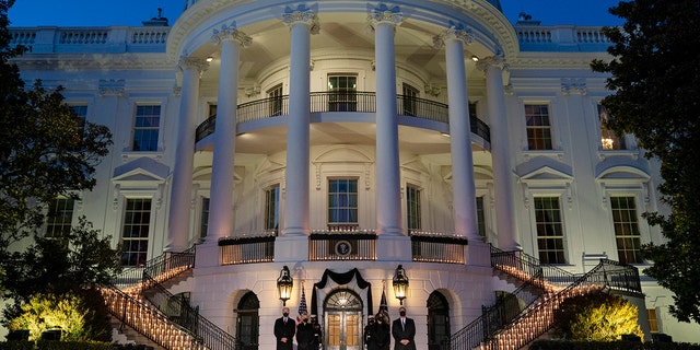 President Joe Biden, first lady Jill Biden, Vice President Kamala Harris, and Doug Emhoff participate in a moment of silence during a ceremony to honor the 500,000 Americans that died from COVID-19, at the White House, Monday, Feb. 22, 2021, in Washington. (AP Photo/Evan Vucci)