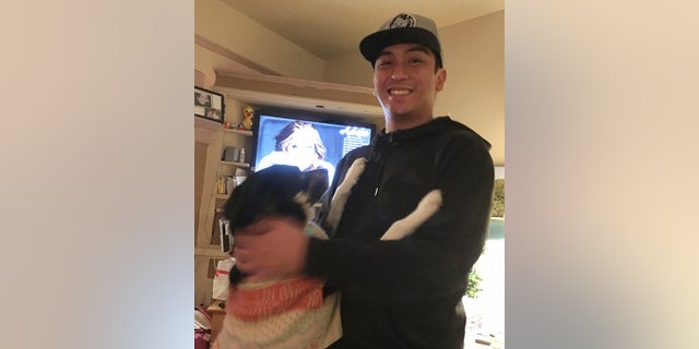 This Jan. 4, 2018 photo provided by Isabella Collins, Navy veteran Angelo Quinto smiles at his home in Berkeley, Calif. (Isabella Collins via AP)