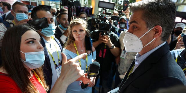 A woman argues with CNN reporter Jim Acosta outside the Conservative Political Action Conference (CPAC) on Friday, Feb. 26, 2021, in Orlando, Fla. 