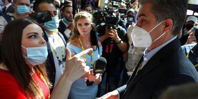 A woman argues with CNN reporter Jim Acosta outside of the Conservative Political Action Conference (CPAC) on Friday, February 26, 2021, in Orlando, Florida.