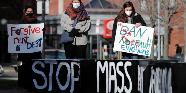 In this Wednesday, Jan. 13, 2021 file photo, Tenants' rights advocates demonstrate outside the JFK federal building in Boston. (AP Photo/Michael Dwyer)