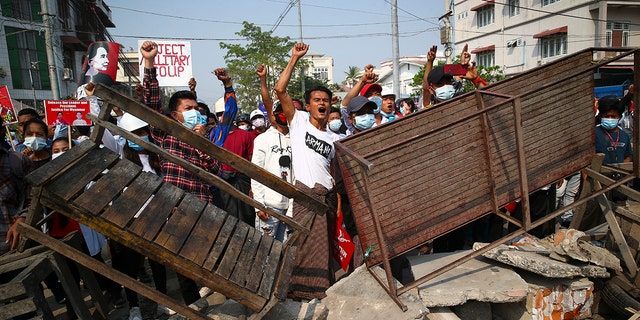 Protesters shout slogans as police arrive during a protest against the military coup in Mandalay, Myanmar, Sunday, Feb. 28, 2021. (Associated Press)