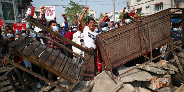 Protesters shout slogans as police arrive during a protest against the military coup in Mandalay, Myanmar, Sunday, Feb. 28, 2021. (Associated Press)