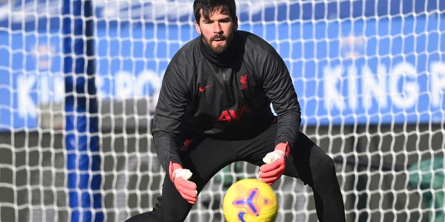 Liverpool's goalkeeper Alisson warms up ahead of the English Premier League soccer match between Leicester City and Liverpool at the King Power Stadium in Leicester, England, Saturday, Feb. 13, 2021. (Michael Regan/Pool Photo via AP)