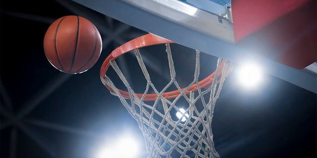 Close-up of a basketball reaching for a hoop