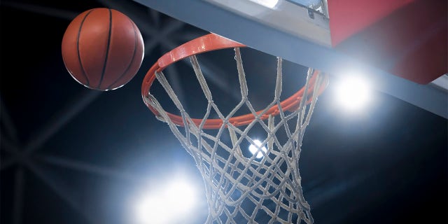 Close-up of a basketball reaching for a hoop