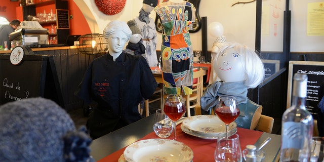 Mannequins with balloon heads representing customers are seen on chairs at tables, installed at restaurant Chez Therese in Rixensart, Belgium. (REUTERS/Johanna Geron)