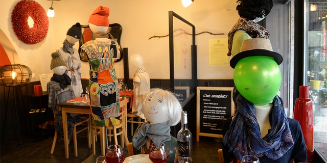 Therese set up the mannequins in her restaurant to denounce the coronavirus restrictions put in place by the Belgian government. (REUTERS/Johanna Geron)