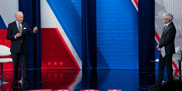 Anderson Cooper listens as President Joe Biden answers questions during a televised town hall event at Pabst Theater, Tuesday, Feb. 16, 2021, in Milwaukee. (AP Photo/Evan Vucci)