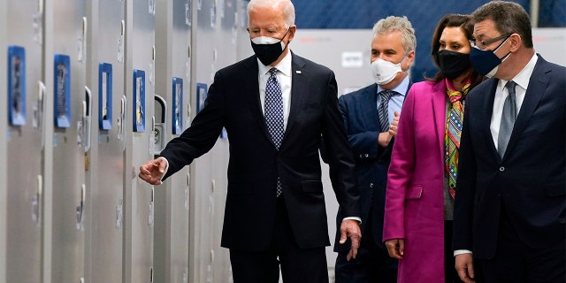 President Joe Biden walks with Albert Bourla, Pfizer CEO, right, Michigan Gov. Gretchen Whitmer, second from right, and Jeff Zients, White House coronavirus response coordinator, as he tours a Pfizer manufacturing site, Friday, Feb. 19, 2021, in Portage, Mich. (AP Photo/Evan Vucci)