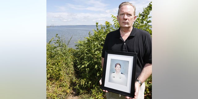 Bill Thomas, a producer on Oxygen's 'Lovers' Lane Murders' is seen here with a portrait of his sister Cathy Thomas.