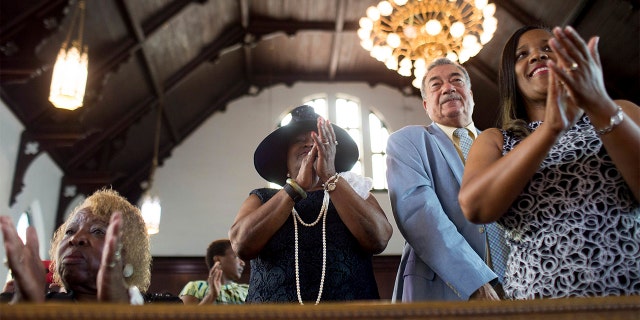 FILE - In this Sunday, July 10, 2016 file photo, parishioners clap during a worship service at the First Baptist Church, a predominantly African-American congregation, in Macon, Ga. (AP Photo/Branden Camp)